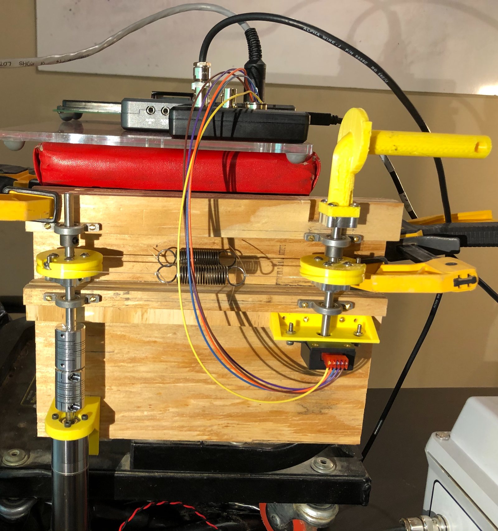 Series Elastic Actuator physical prototype on test bench - yellow 3D-printed parts, springs, wiring, and NI myRIO controller